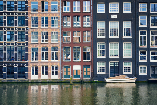 Amsterdam canal Damrak with houses Netherlands by Dmitry Rukhlenko