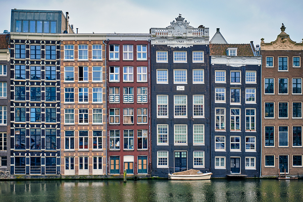 Amsterdam canal Damrak with houses Netherlands by Dmitry Rukhlenko