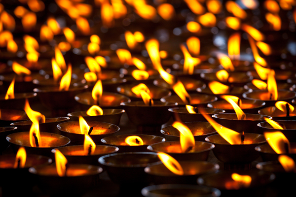 Burning candles in Buddhist temple. McLeod Ganj Himachal Prades by Dmitry Rukhlenko