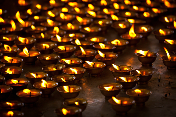 Burning candles in Buddhist temple. McLeod Ganj Himachal Pradesh by Dmitry Rukhlenko