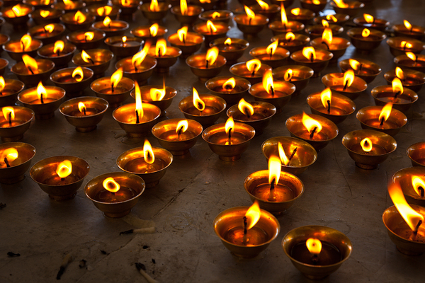 Burning candles in Buddhist temple. McLeod Ganj Himachal Pradesh by Dmitry Rukhlenko