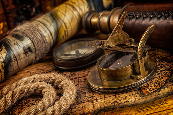 Old vintage compass on ancient map by Dmitry Rukhlenko