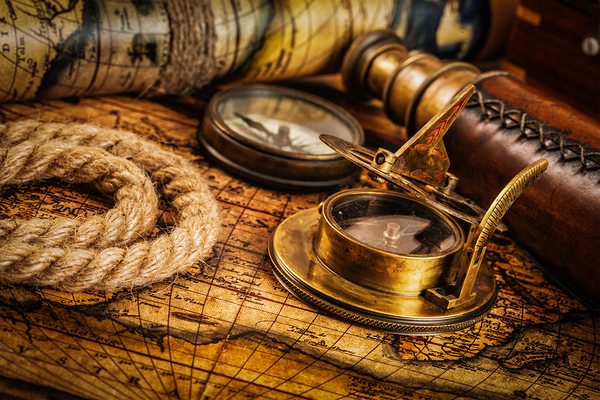 Old vintage compass on ancient map by Dmitry Rukhlenko