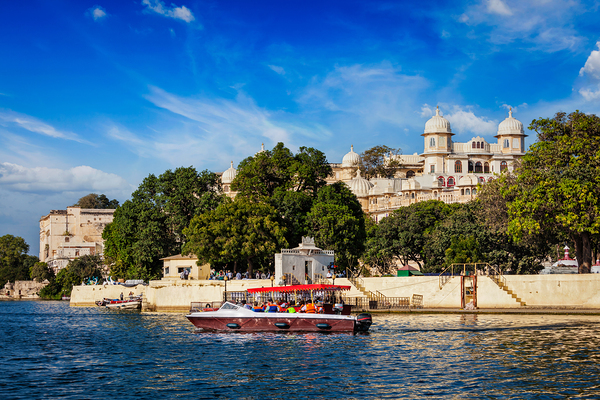 Toruist boat on Lake Pichola with City Palace in background. Udaipur India by Dmitry Rukhlenko