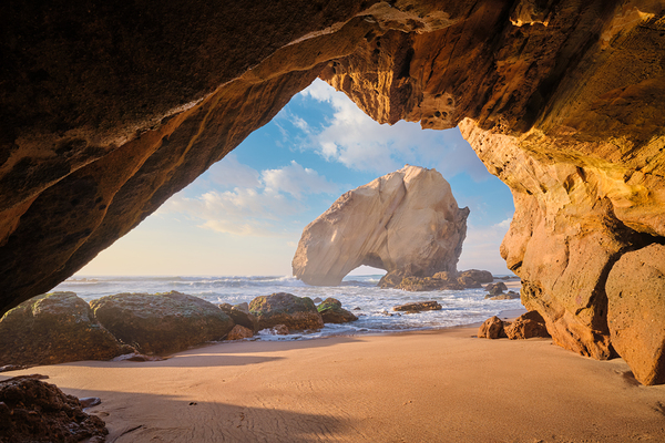Stunning Penedo do Guincho Arch at Praia da Santa Cruz during Sunset by Dmitry Rukhlenko