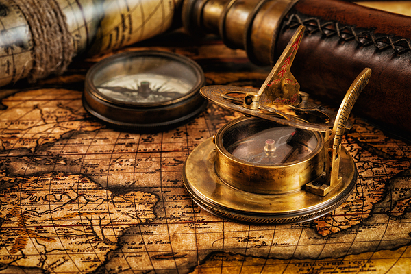 Old vintage compass on ancient map by Dmitry Rukhlenko
