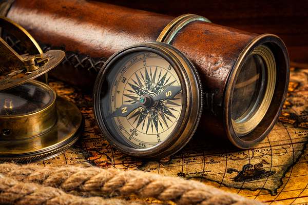 Old vintage compass and navigation instruments on ancient map by Dmitry Rukhlenko