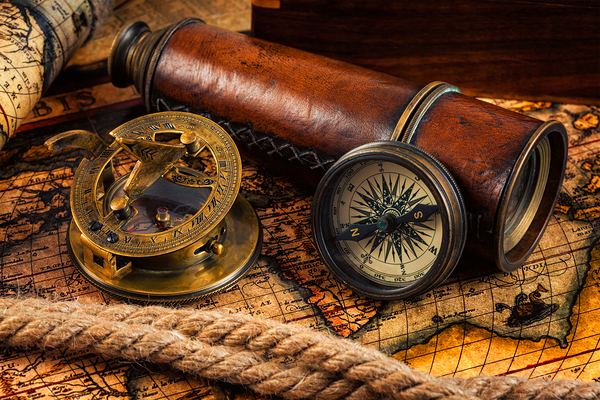 Old vintage compass and navigation instruments on ancient map by Dmitry Rukhlenko