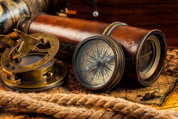 Old vintage compass and navigation instruments on ancient map by Dmitry Rukhlenko