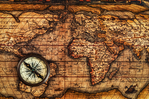 Old vintage compass on ancient map by Dmitry Rukhlenko
