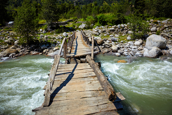 Bridge over river in Himalayas by Dmitry Rukhlenko