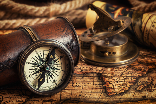 Old vintage compass on ancient map by Dmitry Rukhlenko