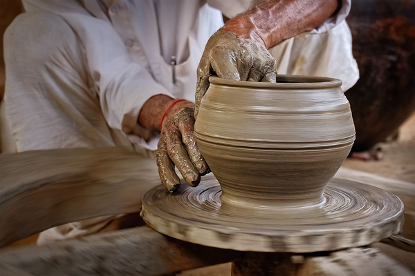 Indian potter at work Shilpagram Udaipur Rajasthan India by Dmitry Rukhlenko