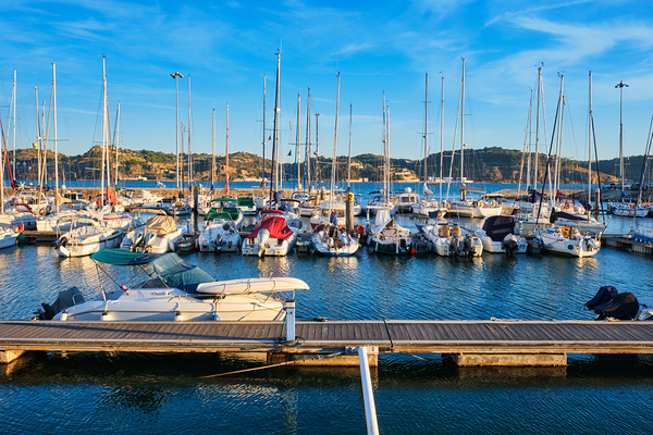 Marina with yachts on sunset in Lisbon Portugal by Dmitry Rukhlenko