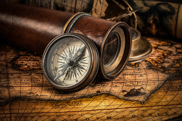 Old vintage compass on ancient map by Dmitry Rukhlenko