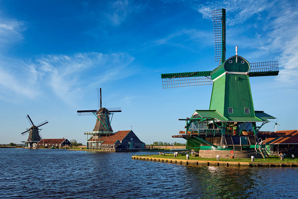 Windmills at Zaanse Schans in Holland on sunset. Zaandam Nether by Dmitry Rukhlenko