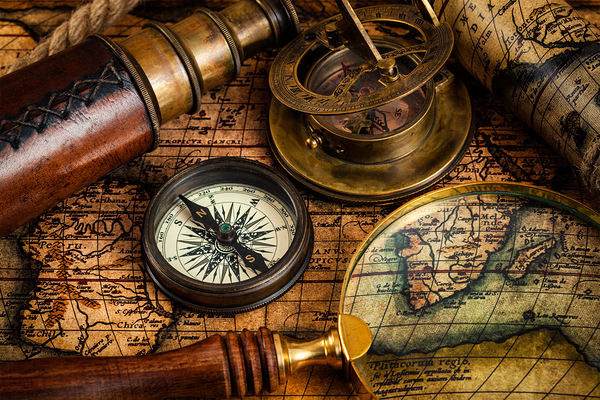 Old vintage compass and travel instruments on ancient map by Dmitry Rukhlenko