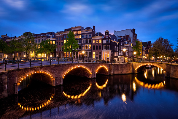 Amsterdam canal bridge and medieval houses in the evening by Dmitry Rukhlenko