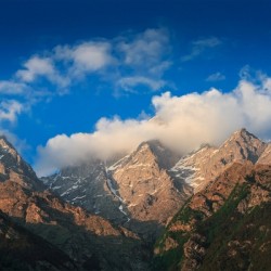 Himalayas summits in clouds on sunset