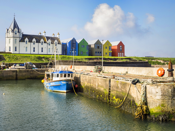 John o Groats the harbour and colourful buildings  by Travelling Light