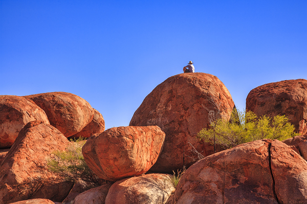 Devils Marbles and Man in a Hat by Travelling Light
