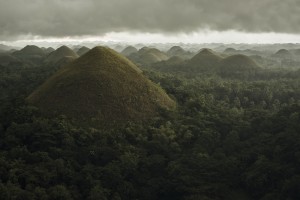 Chocolate hills landscape from Bohol Island, a big storm covers the sky making an interesting lighting effect; Carmen, Bohol Island, Philippines