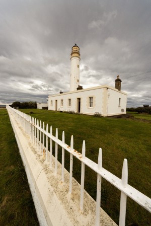 A White Fence Beside Barns Ness Lighthouse; Lothian, Scotland
