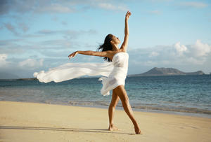Hawaii, Oahu, Lanikai Beach, Beautiful Female Ballet Dancer On Beach Wearing White Flowing Fabric.