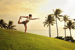 Hawaii, Oahu, Female Doing A Yoga Pose, Stretching On A Hill Overlooking Ocean, Palm Trees And Sunset.