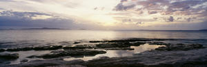 Sunrise Over Ocean And Rocky Coastline; Fiji