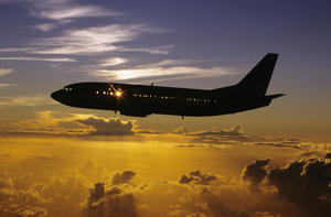 USA, Silhouette of airplane in sunset sky; Hawaii