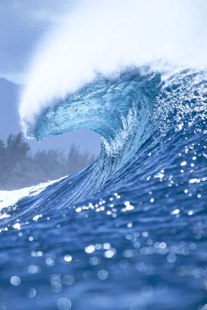 Large Shimmery Blue Wave Curling With Wind Spray, Land Visible In Background