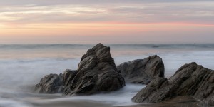 Mist Surrounding Rocks In The Ocean At The Coast At Sunset; Sayulita, Mexico