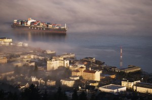 A container ship emerges from the fog; Astoria, Oregon, United States of America