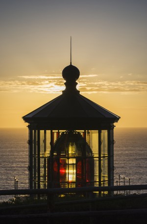 The sun sets at Cape Meares Lighthouse; Oregon, United States of America
