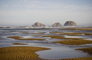 Three Arch Rocks are viewed from the mouth of Netarts Bay; Netarts, Oregon, United States of America
