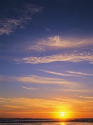 The sun sets at Umpqua Beach; Winchester Bay, Oregon, United States of America