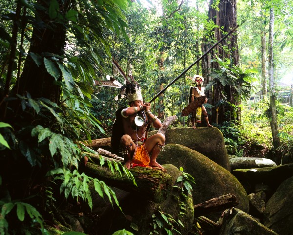 Sarawak men dressed in traditional attire with blowpipes; Sarawak by PacificStock