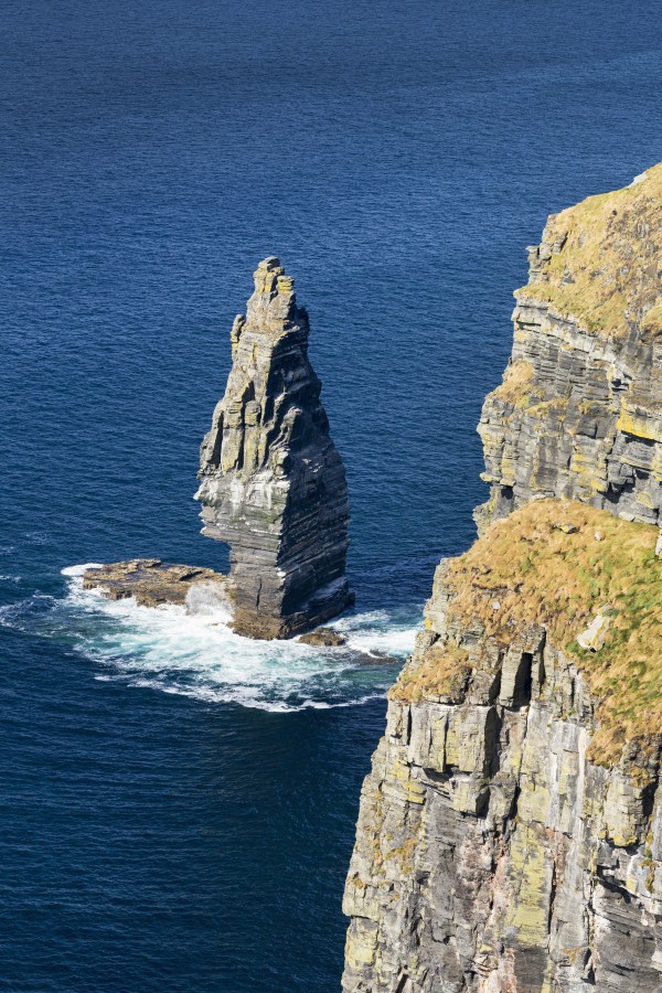 Large sea stack rock structure in the ocean with cliffs; Liscannor, County Clare, Ireland by PacificStock