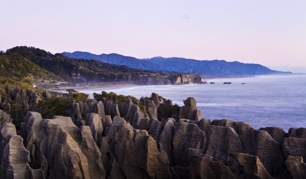 Rock formations at sunset; Punakaiki, South Island, New Zealand by PacificStock