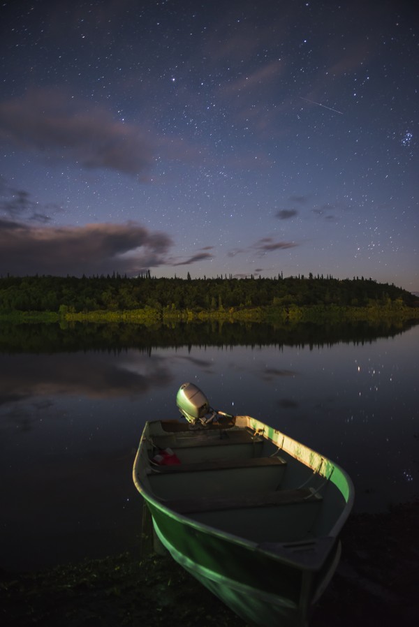 A skiff rests on the banks of the Kvichak River at night, Bristol Bay Region, Southwest Alaska. by PacificStock