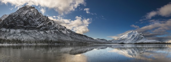 Mt. Dillon and Mt. Sukakpak reflecting in a pond in the Brooks Range north of Wiseman, Arctic Alaska, winter by PacificStock