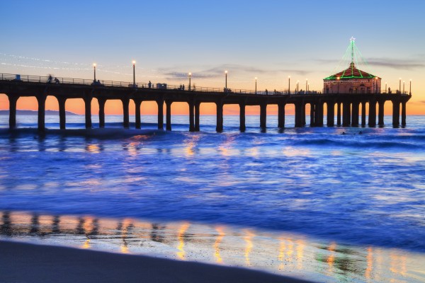 Manhattan Beach Pier at sunset, completed in 1920, Roundhouse Marine Studies Lab and Aquarium (octagonal building, end of pier); Manhattan Beach, California, United States of America by PacificStock