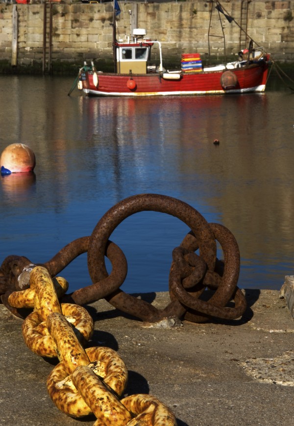 Harbour With Mooring And Fishing Boat by PacificStock