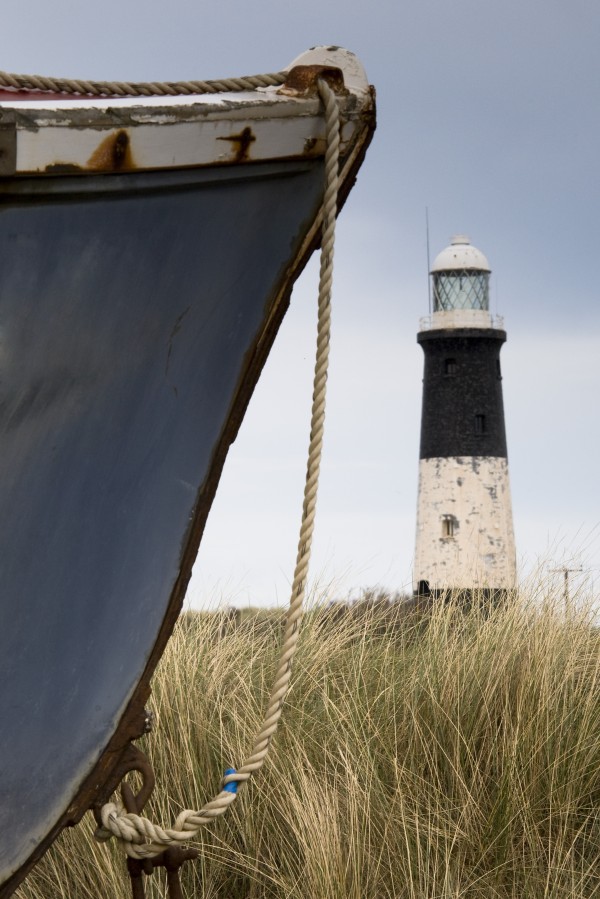 Abandoned Boat And Lighthouse, Humberside, England by PacificStock