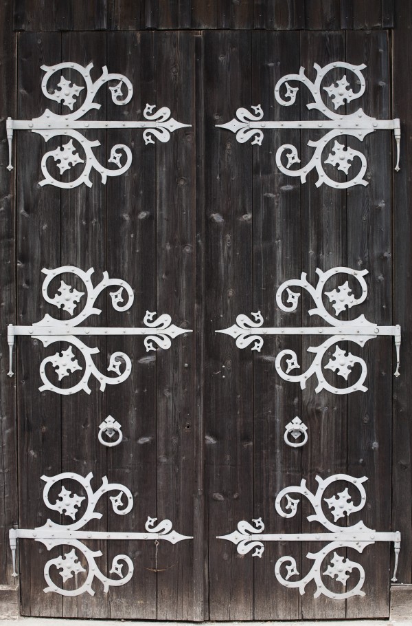 Large Metal Decorative Hinges On A Weathered Wooden Barn Door; Fussen, Germany by PacificStock