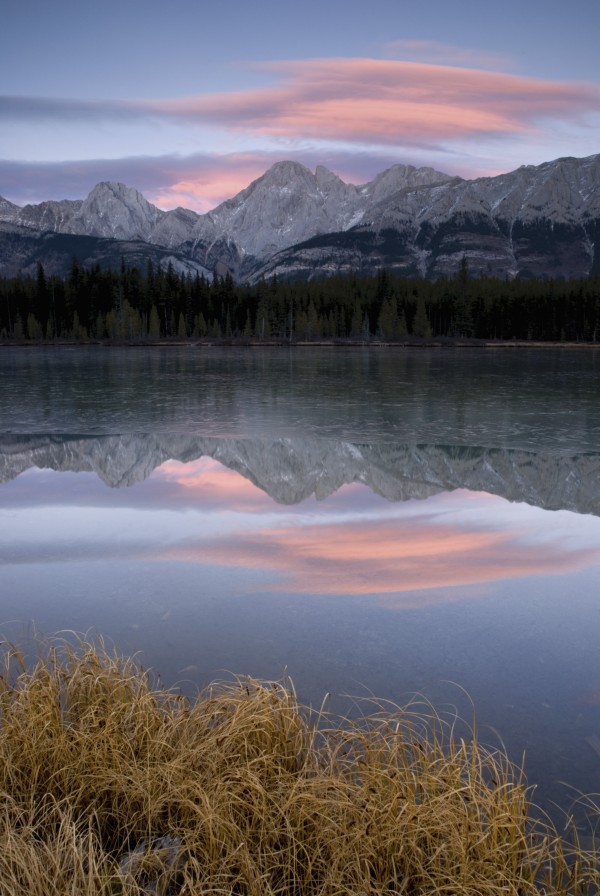 Partially Frozen Spillway Lake At Sunset; Kananaskis, Alberta, Canada by PacificStock