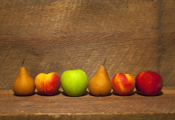 Variety Of Fruit In A Row On A Wooden Shelf; Waterloo, Quebec, Canada by PacificStock
