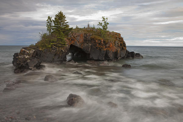 Water Coming Into Shore Around A Rock Formation On Lake Superior; Grand Portage, Minnesota, United States Of America by PacificStock