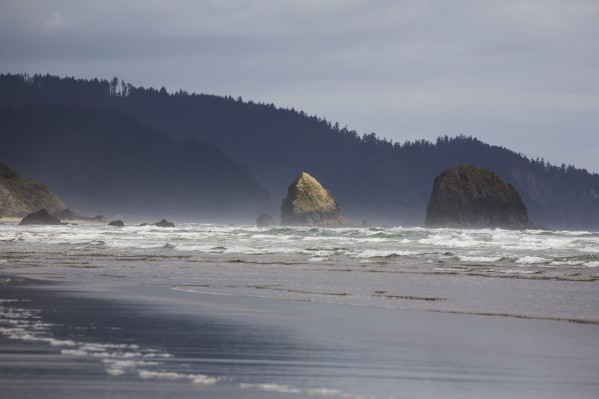 Rock Formations In The Ocean With Waves On The Beach; Cannon Beach, Oregon, United States of America by PacificStock